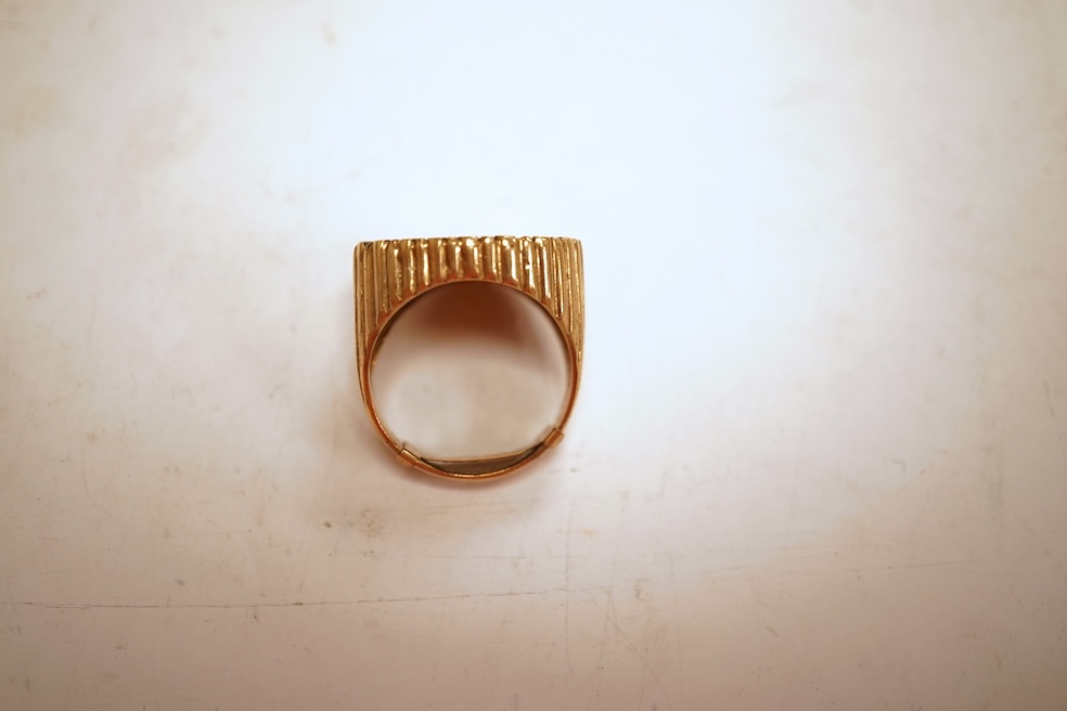 A sovereign ring, 1897 and later, set with a full sovereign dated 1897, to a fluted gold ring mount, size S (sizing band), ring mount stamped 9ct, gross weight 17 grams, Condition: typical surface wear